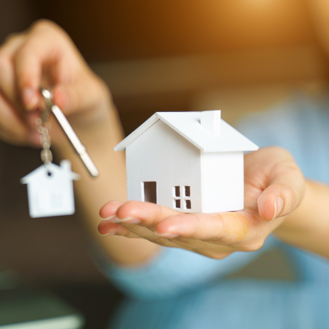 Woman,Holding,White,House,Model,And,House,Key,In,Hand.mortgage